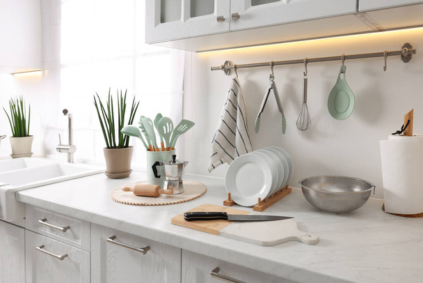 Set of different utensils and dishes on countertop in kitchen - Foto, Imagen