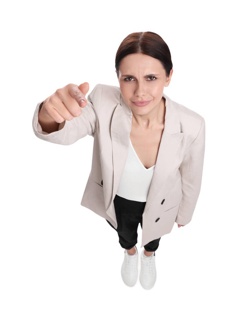 Beautiful businesswoman in suit pointing at something on white background, above view - Foto, Imagem