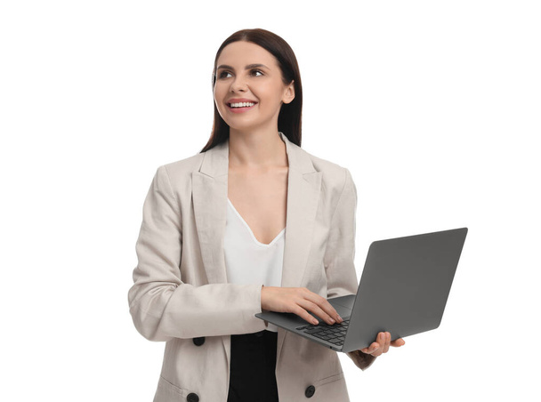 Beautiful businesswoman in suit using laptop on white background - Valokuva, kuva