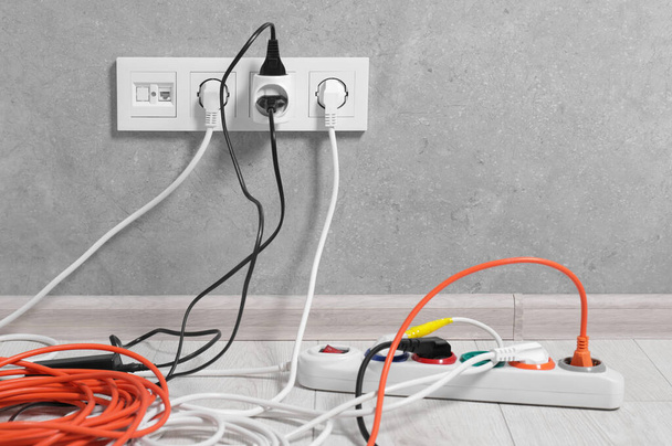 Extension cord with power plugs in sockets indoors, space for text - Фото, изображение