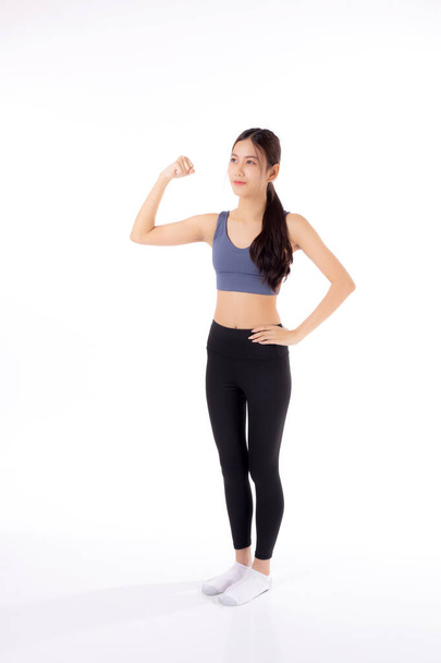 Portrait of beautiful young asian woman in sportwear showing strong muscles isolated on white background, sport and exercise for health, training and strength, female slimming with confident. - Valokuva, kuva