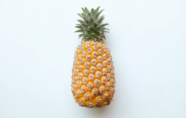copy space and top view,flat lay fresh a pineapple (Ananas comosus (L.) Merr) ripe yellow organic isolate on a white backdrop. summer fruits concept. - Zdjęcie, obraz