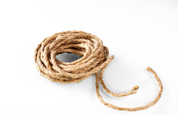 Skein of textured rope yarn on white background with shadows. - Foto, afbeelding