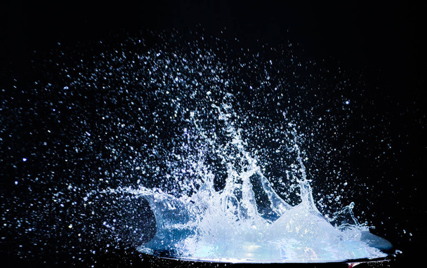 Splashing water on a black background. water splash refreshing black background - Photo, image