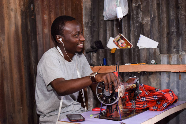 Jos, Plateau State - April 21, 2021: African Tailor Sewing at workshop - Foto, afbeelding