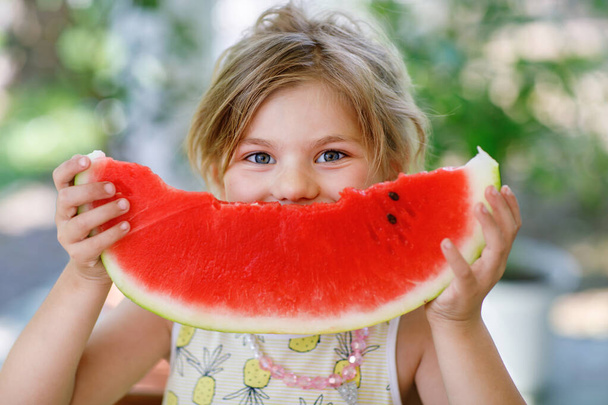 Little Girl, Preschooler, Delights in a Juicy Watermelon on a Sunny Summer Day. Child sharing a Healthy Snack with Her Family, She Embraces the Joy of Summertime Bliss. - Photo, Image