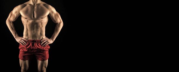 cropped view of fitness man abs. muscular abs of fitness man isolated on black background. studio shot of muscular abs. sport and fitness. muscular man with abs, copy space. - 写真・画像