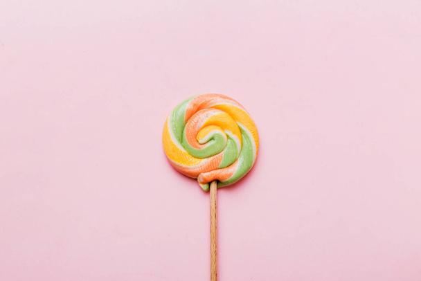 Colorful candies, lollypop on the colorful background, multicolored minimal style top view. - 写真・画像