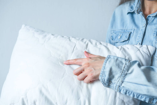 Beyaz bir yastıkta parmakla işaret eden yüzü olmayan kadın. Sağlık sorunları ve uyku bozuklukları. Yüksek kalite fotoğraf - Fotoğraf, Görsel