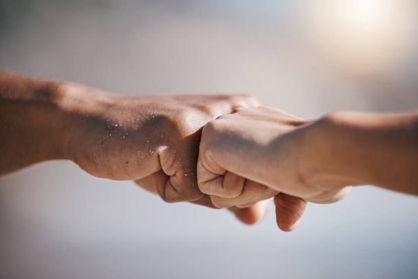 Man, hands and fist bump for teamwork, partnership or unity in solidarity or community in the outdoors. Hand of friends bumping fists together for team goals, support or motivation in collaboration. - Фото, изображение