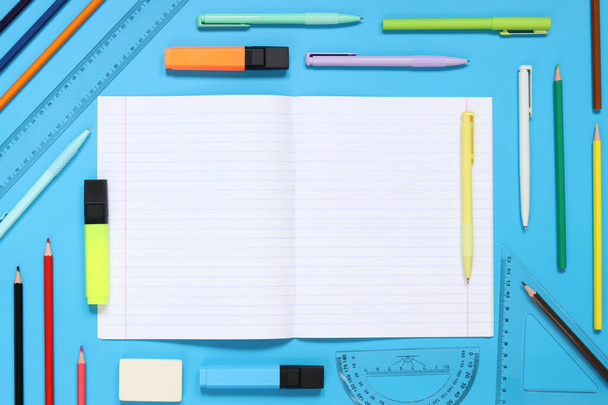 Mockup open notepad with stationery on a blue background. Top view, flat lay. Diary for entries, copy space. Open notebook with space for text with colorful school supplies - Photo, Image