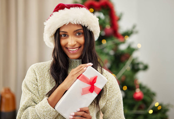 Woman, Christmas present and smile in portrait, celebrate holiday with happiness and wrapped box with ribbon. Special event, female person at home with gift giving and package, festive and xmas. - Photo, Image