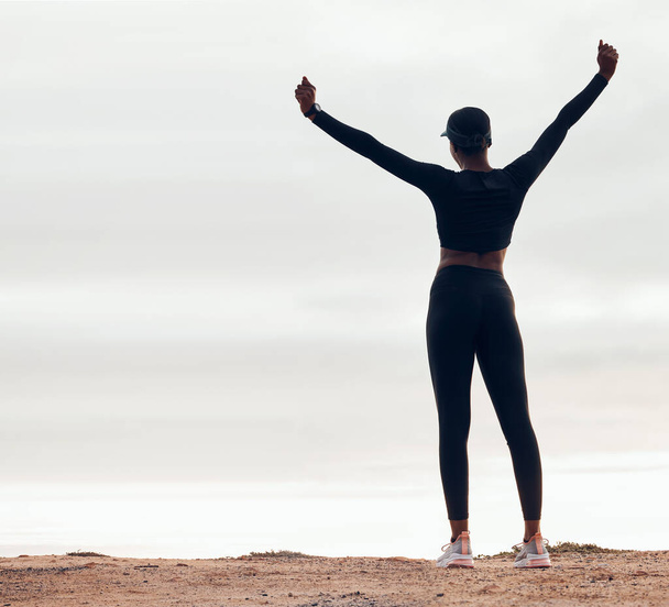 Celebration, fitness and back of woman in nature with achievement, success and workout goals. Sports, mockup space and happy female person with hands in air for exercise, training and running target. - Fotoğraf, Görsel