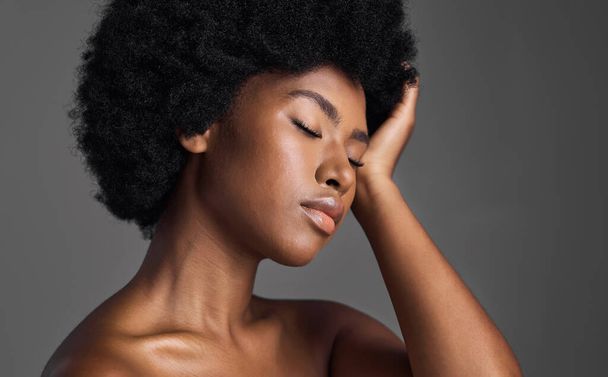 Natural beauty, hair care and black woman with skincare, dermatology and confident girl on a grey studio background. Female person, luxury or model with makeup, cosmetics and aesthetics with grooming. - 写真・画像