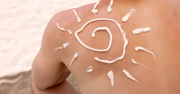 Sun shaped sunscreen applied to man back 4k movie. Summer skin care concept - Footage, Video