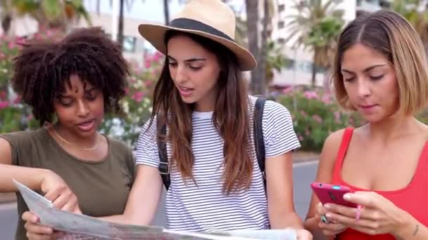 市内の夏休み観光を楽しむマップを探している3人の多人種女性の友人。旅行と休日のコンセプト. - 映像、動画