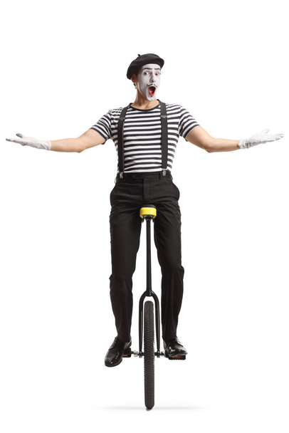 Mime riding a unicycle isolated on white background - Foto, Imagen