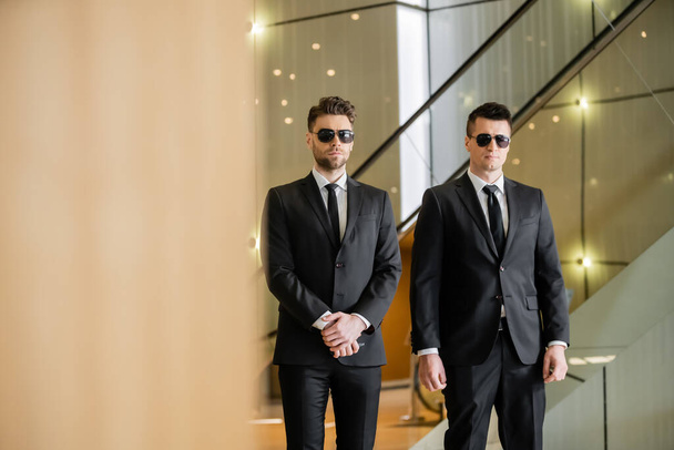 security guards, two handsome men in formal wear and sunglasses, bodyguards on duty, safety measures, vigilance, black suits and ties, private security, strong men  - Photo, Image