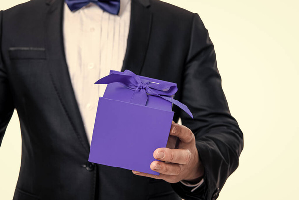 selective focus of occasion present isolated on white background. man with occasion gift in studio. man hold occasion present box. man holding gift for occasion. - Foto, immagini