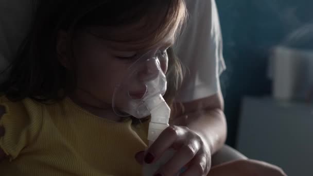 un niño pequeño usando nebulizador en casa niño pequeño usando inhalador de vapor máscara inhalación en casa procedimiento médico tratamiento de medicamentos asma neumonía bronquitis enfoque selectivo - Imágenes, Vídeo