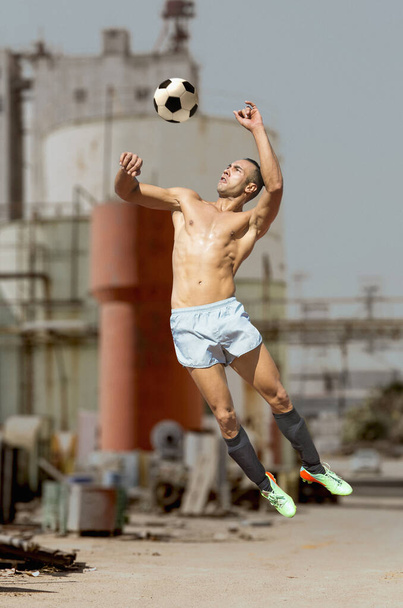 soccer player playing street soccer by day - Foto, imagen