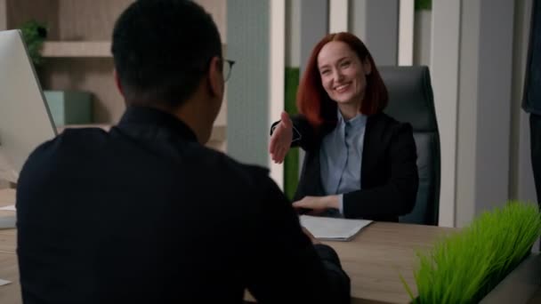Caucasian smiling businesswoman employer talk to client hire candidate recruit business meeting shake hand handshake with customer at office successful deal partners agreement multiracial partnership - Footage, Video