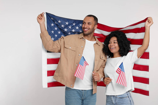 4th of July - Independence Day of USA. Happy couple with American flags on white background - Foto, immagini