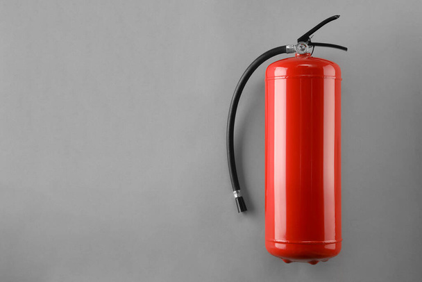Fire extinguisher on light grey background, top view. Space for text - Foto, afbeelding