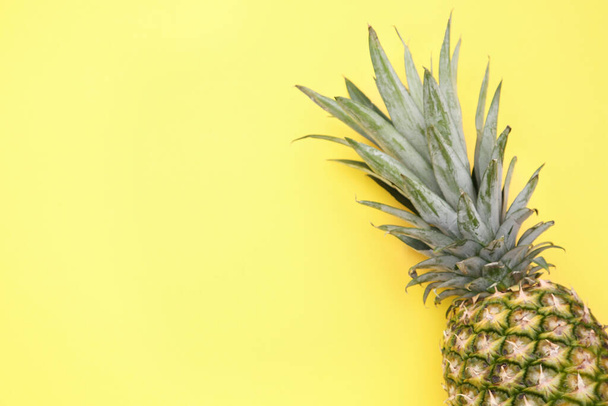 Delicious ripe pineapple on yellow background, top view. Space for text - 写真・画像