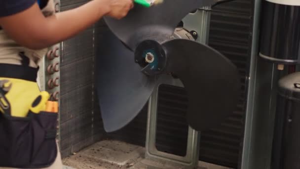 Meticulous specialist sweeping away loose debris accumulated around air conditioner interior base. Worker cleaning built up layer of dirt from internal components to prevent cooling capacity reduction - Footage, Video