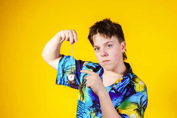 Affective teenage boy with watch showing time - Фото, изображение