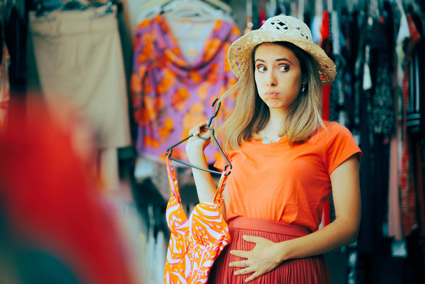 Woman Feeling Bloated Thinking and Choosing a Bathing Suit Stressed girl feeling self-conscious buying swimsuits  - Photo, Image