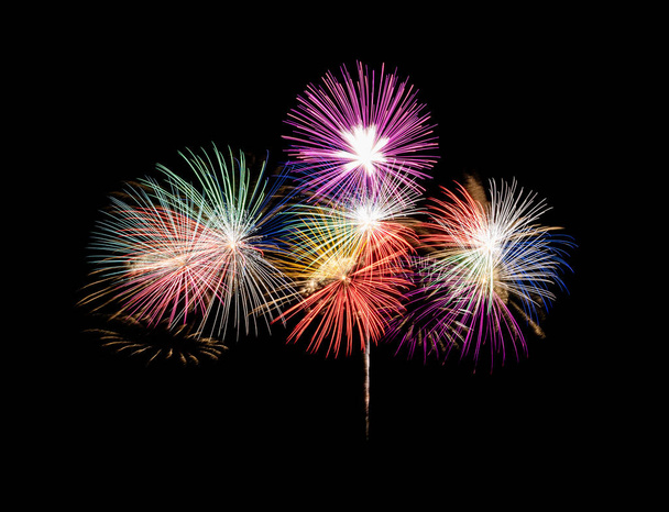 Fuochi d'artificio colorati esplodono sul cielo nero. Concetto di celebrazione e anniversario - Foto, immagini