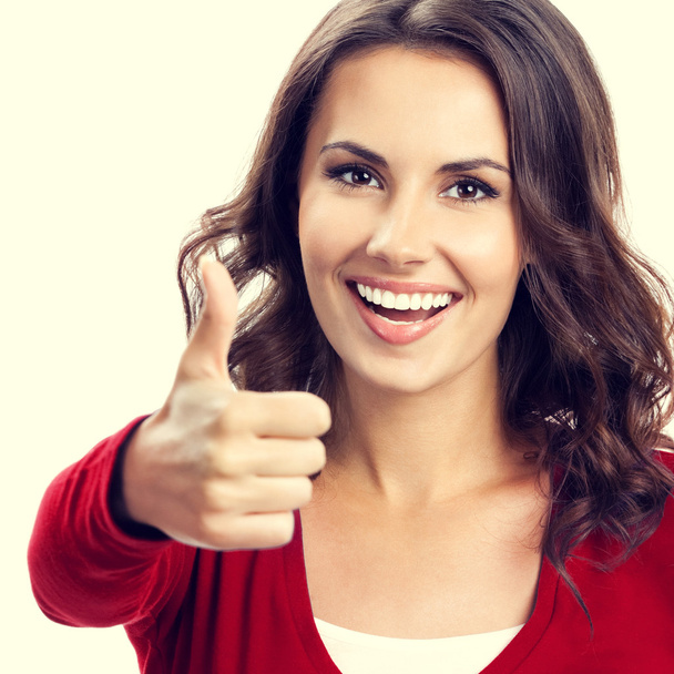 Young woman showing thumbs up gesture - Foto, imagen