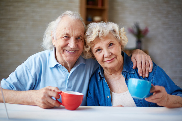 Affectionate seniors with teacups - Fotó, kép