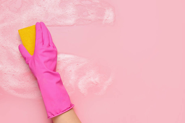 Woman with sponge and foam cleaning on pink background - Фото, изображение