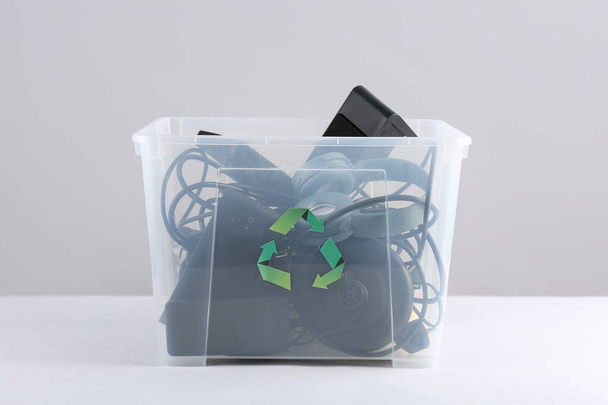 Recycle bin with different household appliances on grey background - Foto, immagini