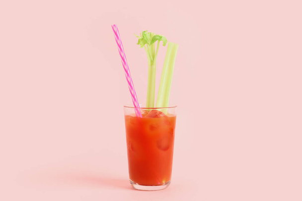 Glass of bloody mary with celery on pink background - Photo, Image