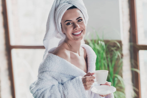 Portrait of sensual lady wear head turban bathrobe enjoy early morning coffee porcelain mug after shower prepare day indoors. - Фото, изображение