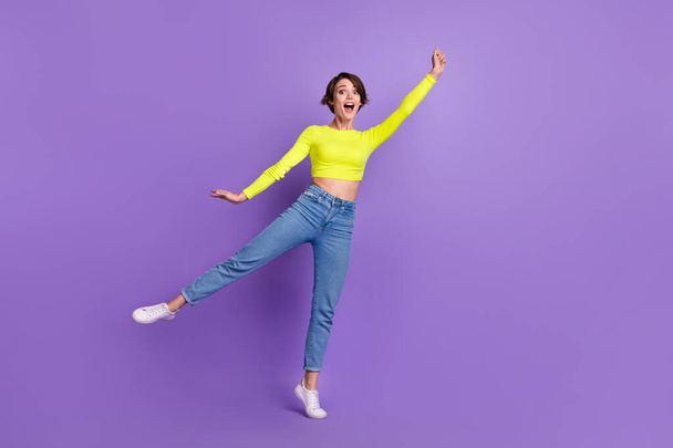 Full body photo of cheerful pretty lady dancing hand hold empty space umbrella isolated on violet color background. - Fotografie, Obrázek