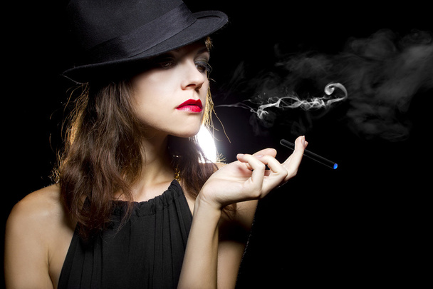 Female vaping an electronic cigarette - 写真・画像
