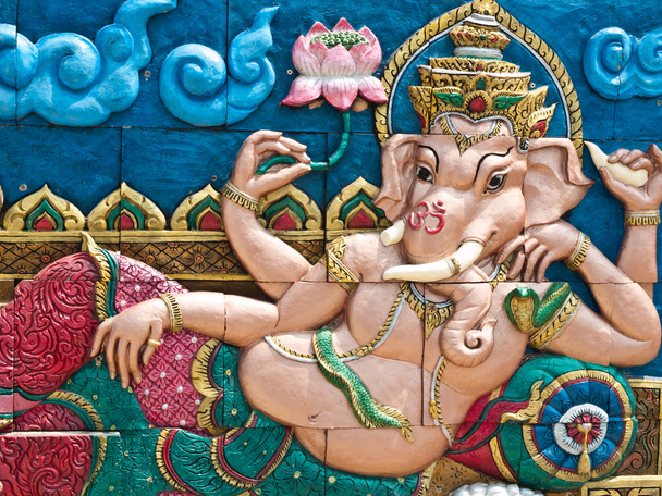 Deus Hindu Dourado Ganesh na parede
 - Foto, Imagem