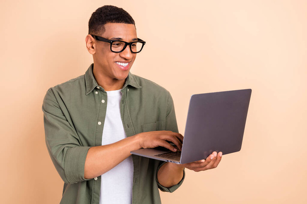 Portrait of positive smart digital marketing expert hold use wireless netbook coworking isolated on beige color background. - Fotografie, Obrázek