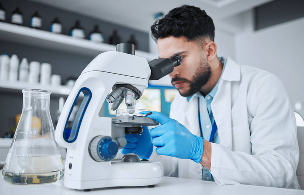 Microscope, science and research with man in laboratory for pharmacy, medical and vaccine. Chemistry, healthcare and medicine with scientist and study for solution, development and sample results. - Photo, Image