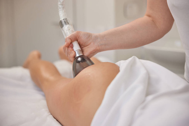 Cosmetology, vacuum roller massage, modern medical. In clinic, vacuum body massage, problems areas slimming, suitable equipment for body care professional, lpg massage procedure, anti-cellulite - Φωτογραφία, εικόνα