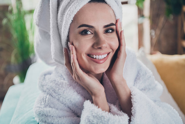 Closeup photo of young female home alone after shower wear bathrobe hair turban apply nurturing cream cheeks face. - Foto, imagen