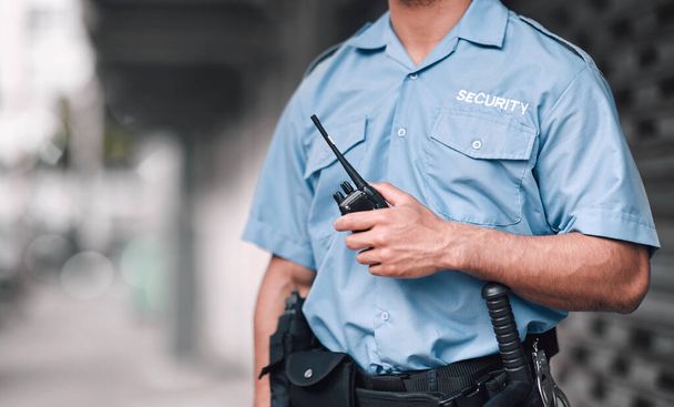 Walkie talkie, security guard or safety officer man on the street for protection, patrol or watch. Law enforcement, hand and duty with a crime prevention male worker in uniform in the city. - Φωτογραφία, εικόνα
