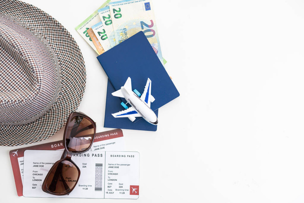 tourist stuff with passport and hat on white background top view - Foto, Bild