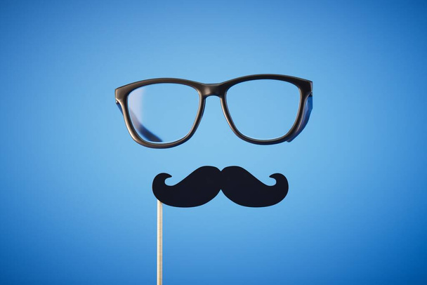 fake mustache and glasses on a blue background. 3D render. - 写真・画像