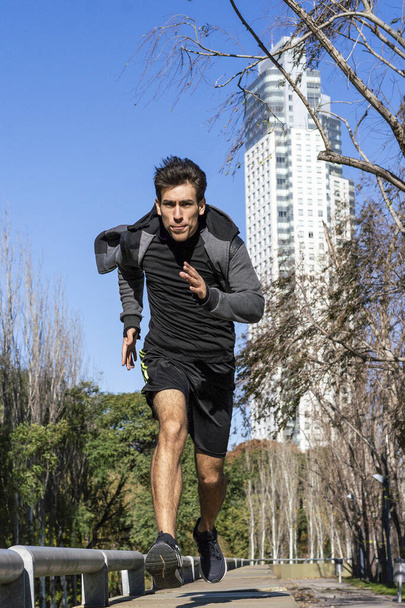 Runner athlete silhouette running fast in public park. - Foto, immagini